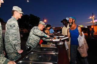 Master SSgt Brian LeClair serves chili mac' to the homeless attending the weekly outside soup kitchen organized by Nellis Air Force Base airmen at the intersection of G Street and West McWilliams Avenue in Las Vegas Monday, August 27, 2012.